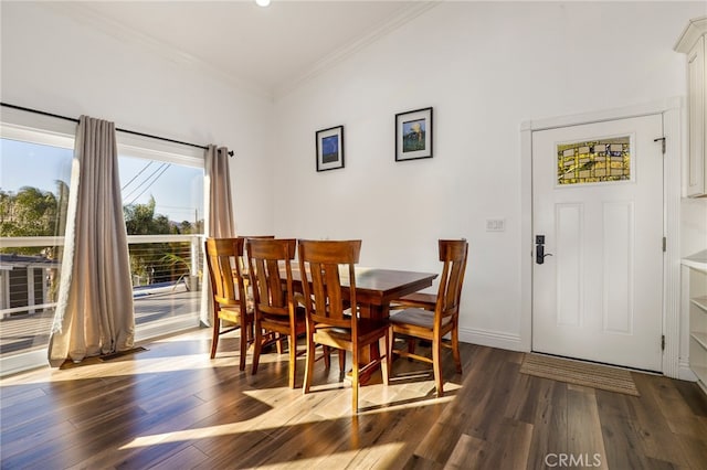 dining area featuring ornamental molding and dark hardwood / wood-style flooring