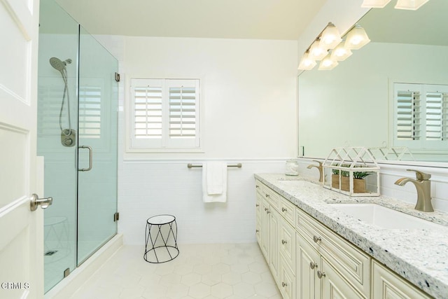 bathroom featuring vanity, tile patterned flooring, and a shower with shower door