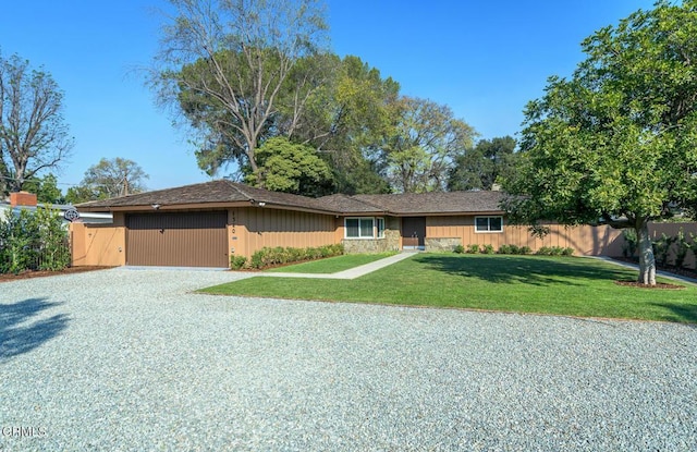 single story home featuring a front yard and a garage