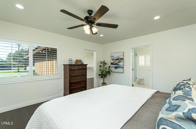 bedroom with ensuite bath, ceiling fan, and dark hardwood / wood-style floors