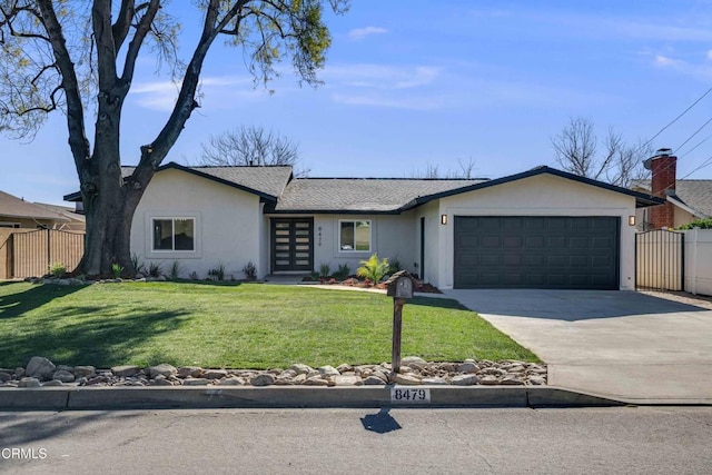 ranch-style house featuring a front yard and a garage