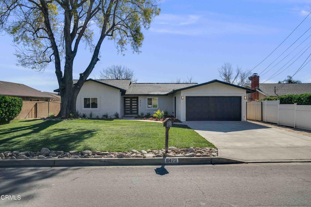 ranch-style home featuring a front lawn and a garage