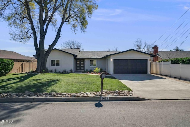 ranch-style home featuring a front lawn and a garage