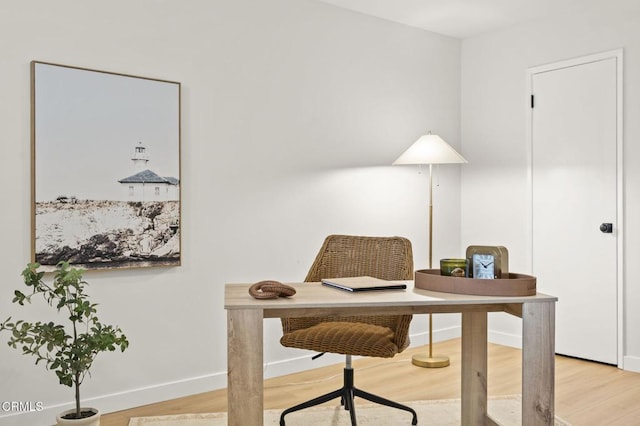 home office with light hardwood / wood-style flooring