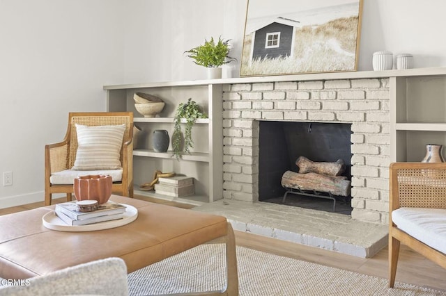 sitting room featuring a fireplace and wood-type flooring