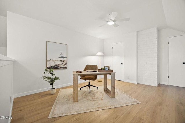 office featuring vaulted ceiling, light wood-type flooring, and ceiling fan