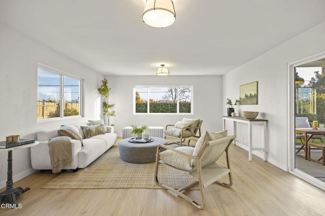 living room featuring light wood-type flooring and radiator heating unit