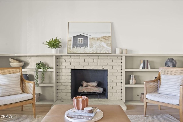 living area featuring a brick fireplace