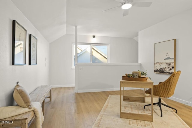 office area featuring ceiling fan, light wood-type flooring, and lofted ceiling