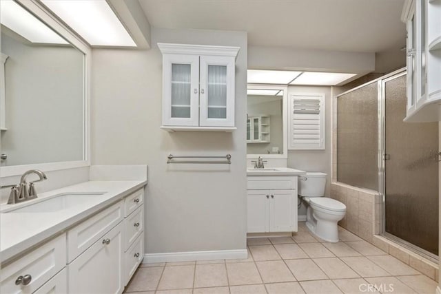 bathroom featuring toilet, vanity, and tile patterned floors