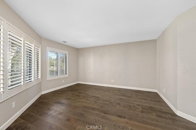 spare room featuring dark hardwood / wood-style flooring