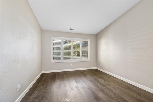 unfurnished room with dark hardwood / wood-style floors