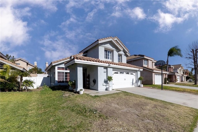 view of front of property featuring a front yard and a garage