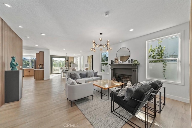 20 Flores, Lake Forest, CA 92610 - living room with light wood-type flooring, an inviting chandelier, and a textured ceiling