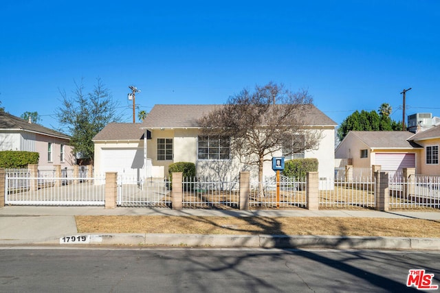 view of front of house with central AC and a garage