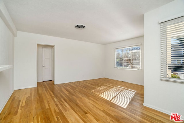 spare room featuring light wood-type flooring