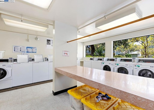 laundry area with washing machine and dryer and plenty of natural light