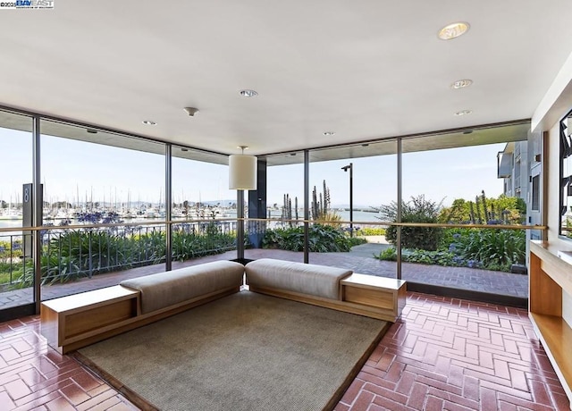 unfurnished sunroom featuring a water view