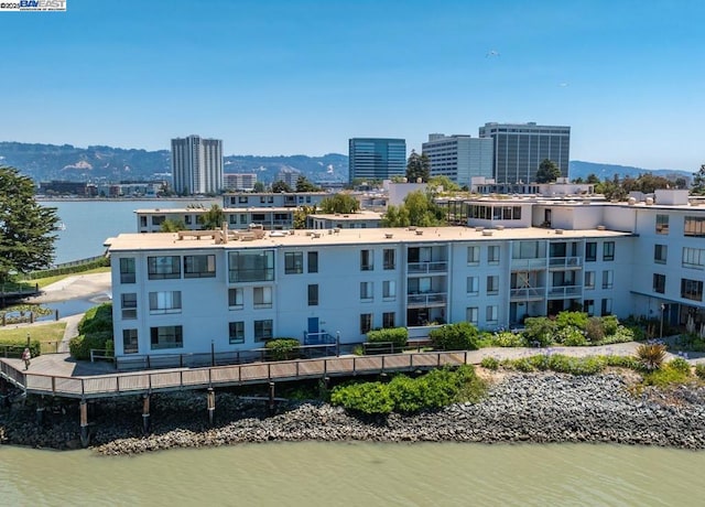 exterior space with a water and mountain view