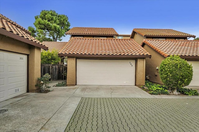 mediterranean / spanish-style home with a garage