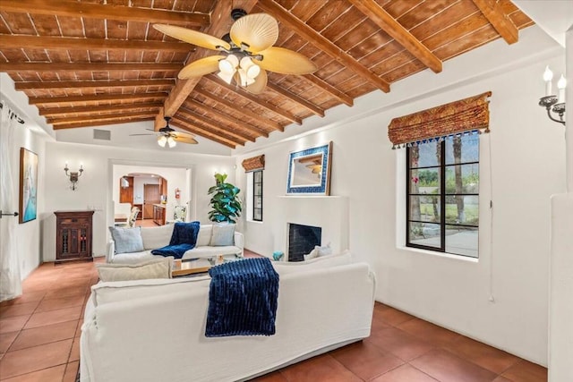 tiled living room featuring ceiling fan, wood ceiling, and lofted ceiling with beams