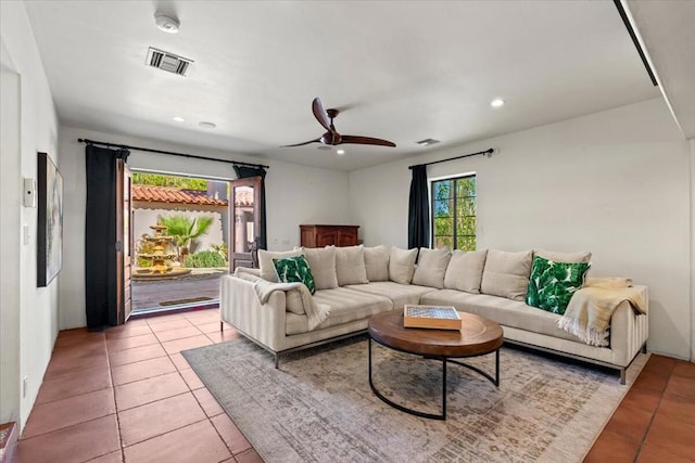 tiled living room featuring ceiling fan