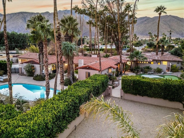 view of home's community featuring a mountain view and a swimming pool