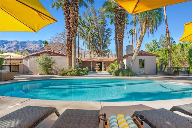 view of pool with a mountain view and a patio area