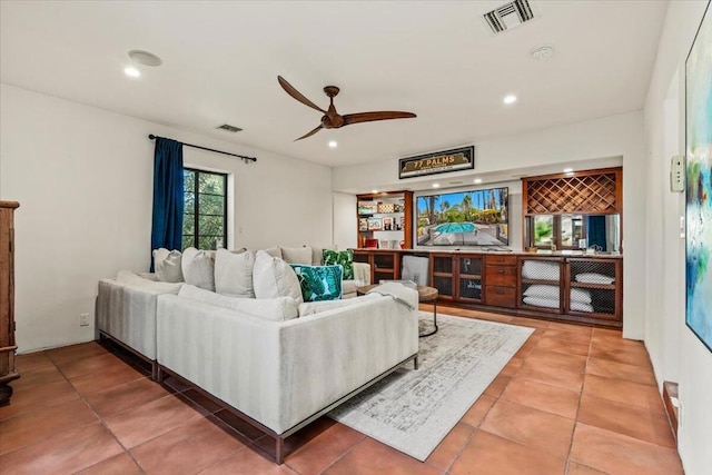 living room featuring ceiling fan and tile patterned floors