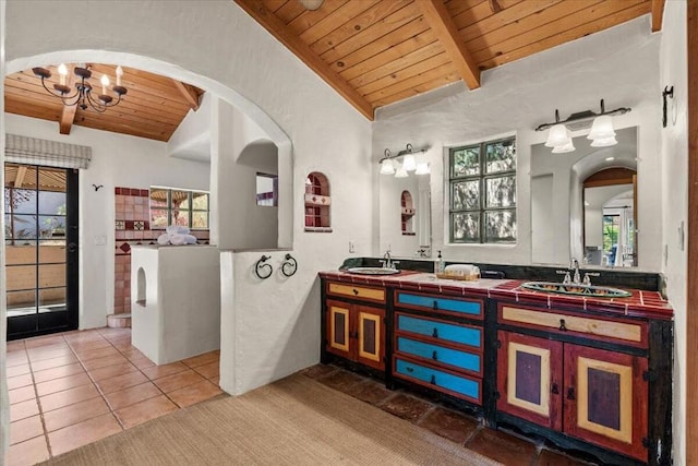 bathroom featuring vanity, tile patterned floors, lofted ceiling with beams, a chandelier, and wooden ceiling