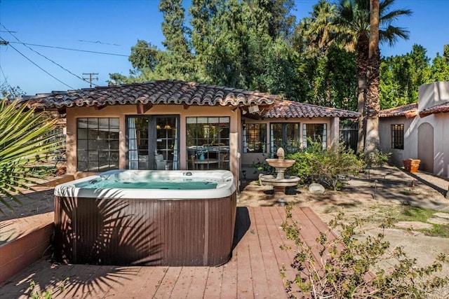 exterior space with a wooden deck and a hot tub