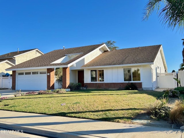 ranch-style home featuring a garage and a front lawn