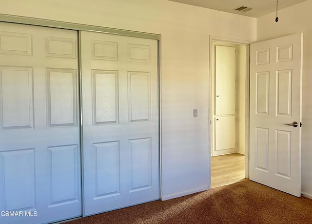 unfurnished bedroom with carpet floors and a closet