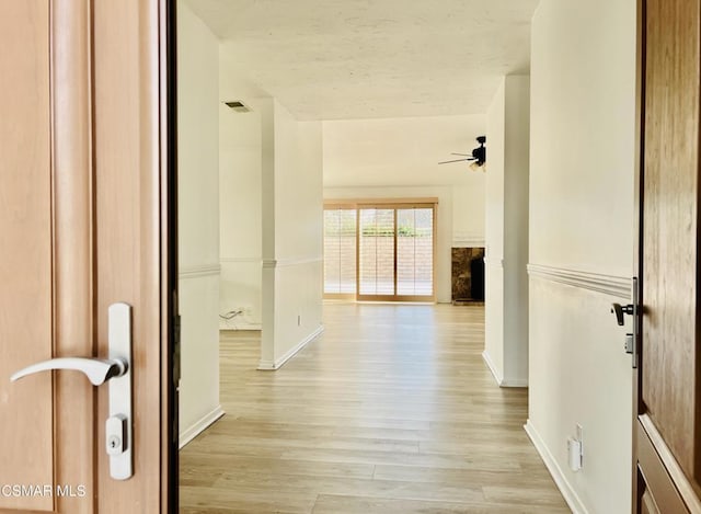 hallway with light hardwood / wood-style flooring