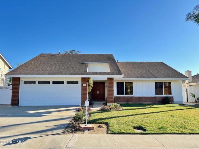 view of front property with a garage and a front yard