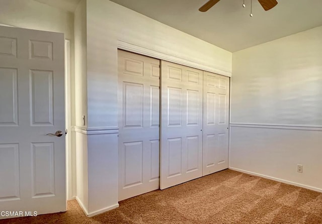 unfurnished bedroom featuring carpet flooring, ceiling fan, and a closet