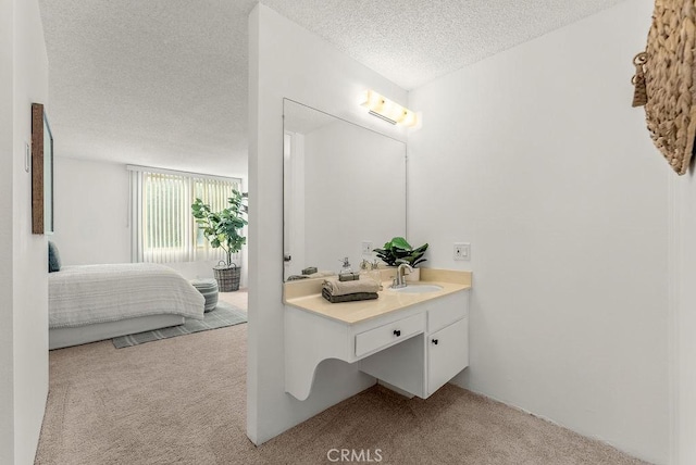 bathroom with a textured ceiling and vanity