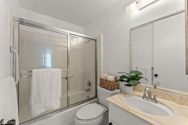 full bathroom with toilet, enclosed tub / shower combo, and vanity