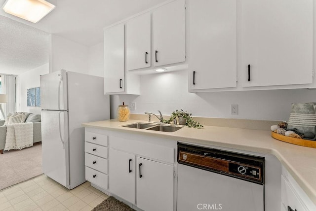 kitchen featuring light carpet, sink, white cabinets, and white appliances