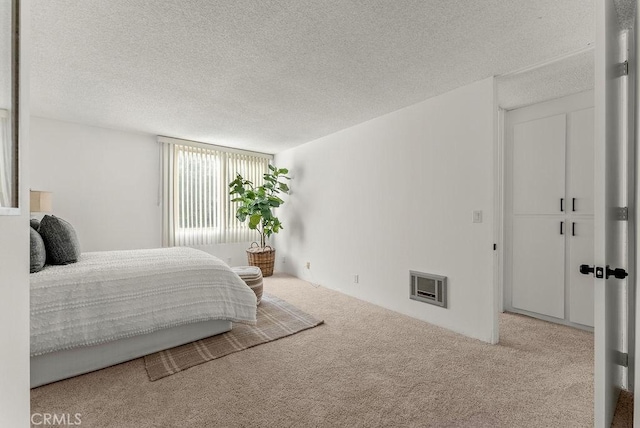 carpeted bedroom featuring a textured ceiling