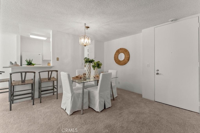 carpeted dining space with an inviting chandelier and a textured ceiling