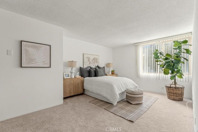 carpeted bedroom featuring a textured ceiling