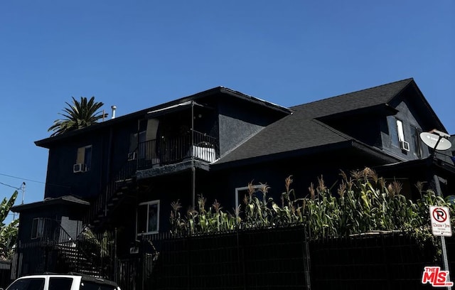 view of side of home with a balcony