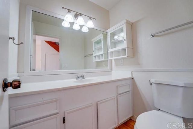 bathroom featuring toilet and vanity