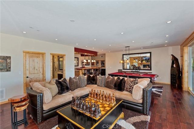 living room featuring dark wood-type flooring and bar area