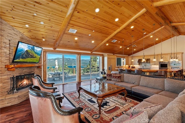 living room with wooden ceiling, dark hardwood / wood-style floors, a stone fireplace, and beamed ceiling