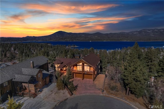 aerial view at dusk with a water and mountain view