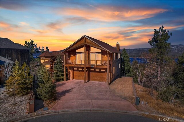 contemporary house with a balcony, a garage, and a mountain view