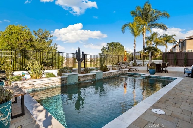 view of pool with a patio area and an in ground hot tub