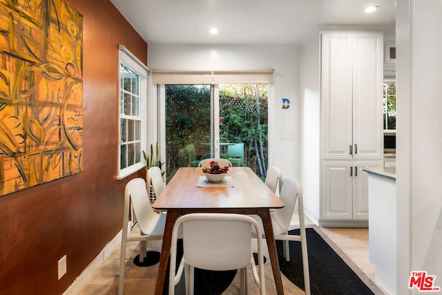 dining room featuring a healthy amount of sunlight and light hardwood / wood-style flooring